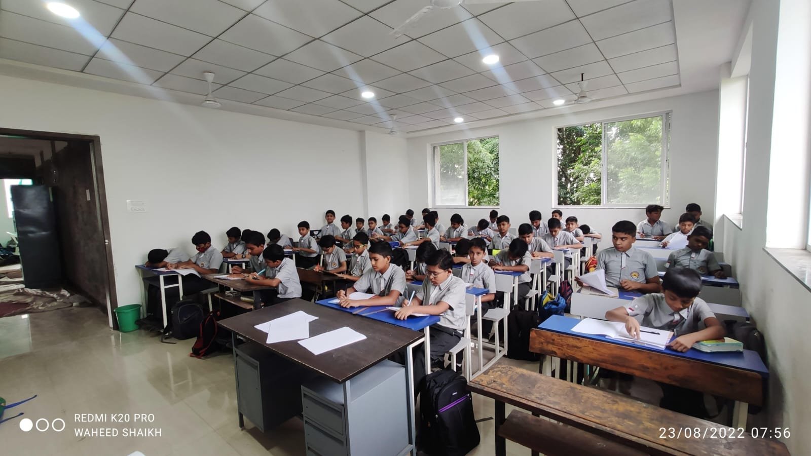 Bright school campus corridor with students learning together